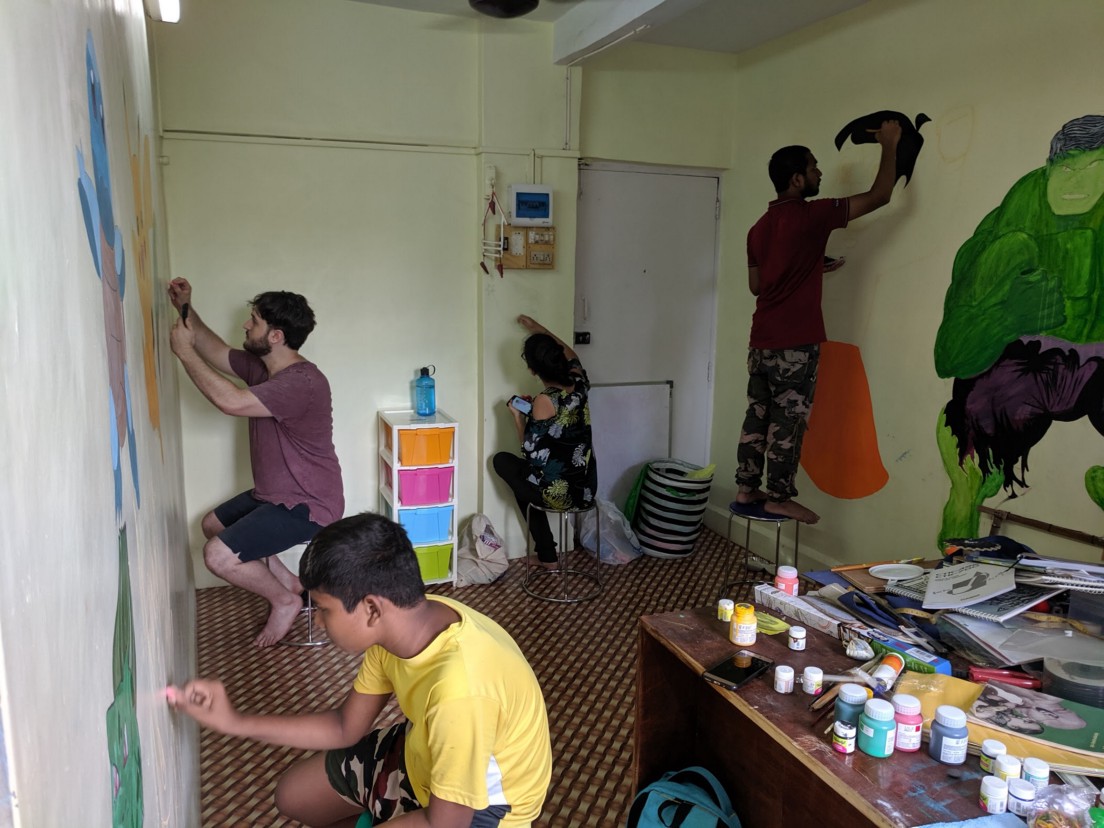 Makers paint walls at MakerGhat in India.
